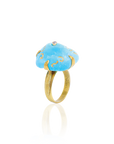 Ring with blue stone and gold accents on a white background