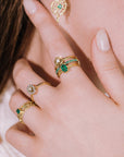 Model wearing collection of gold diamond and emerald rings from Marilisi