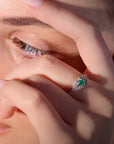 Marilisi artisan fine jewelry White gold diamonds green emerald symmetrical art deco ring on model close up