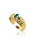 Gold ring with emerald stones on a white background