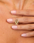 Gold necklace with a pendant worn by a model