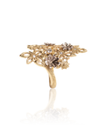Gold ring with floral design and embedded stones on a white background