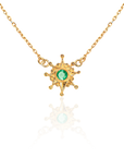 Gold necklace with a green gemstone pendant on a white background