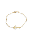 Gold bracelet with a key charm on a white background