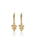 Gold leaf-shaped earrings on a white background