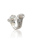 Silver ring with pearl stones on a white background