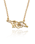 Gold necklace with a detailed pendant on a white background