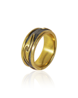 Gold ring with a reflective surface on a white background