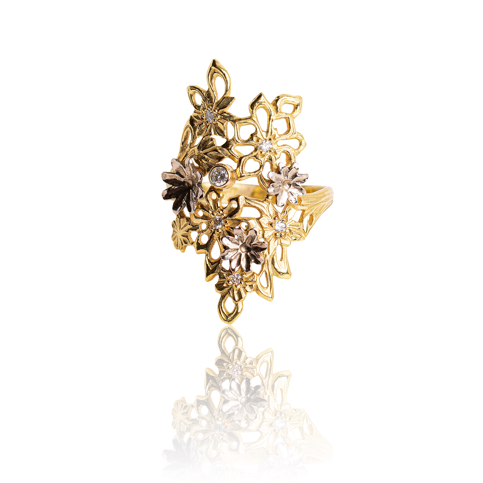 Gold and silver floral ring on a white background