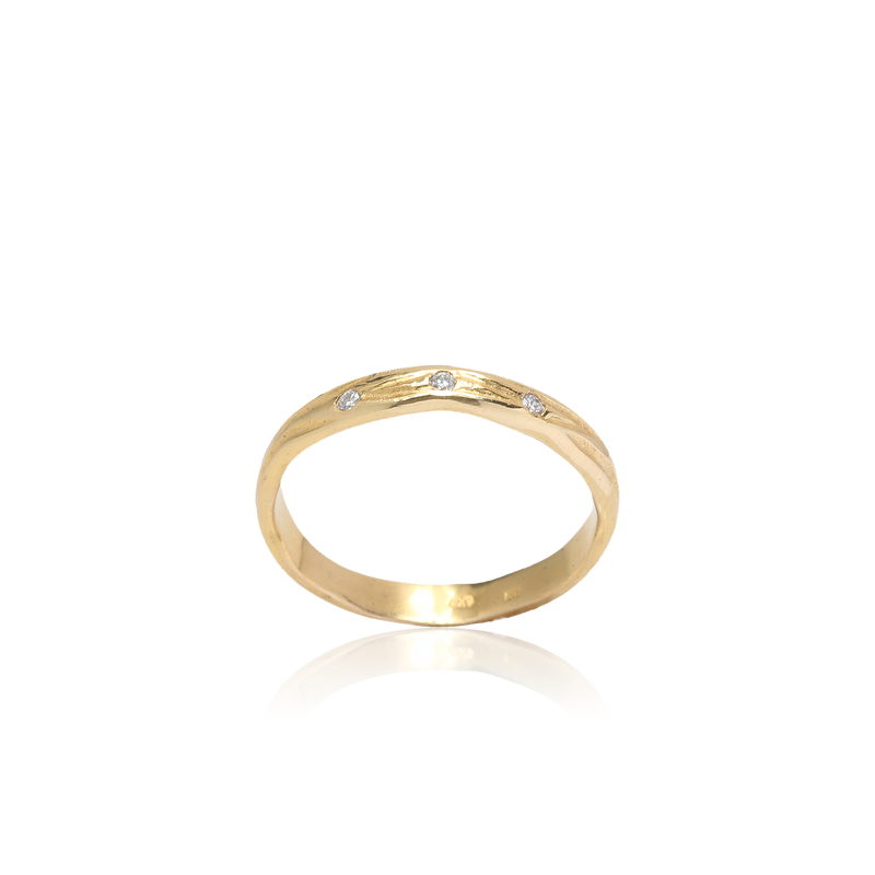 Gold ring with small diamonds on a white background