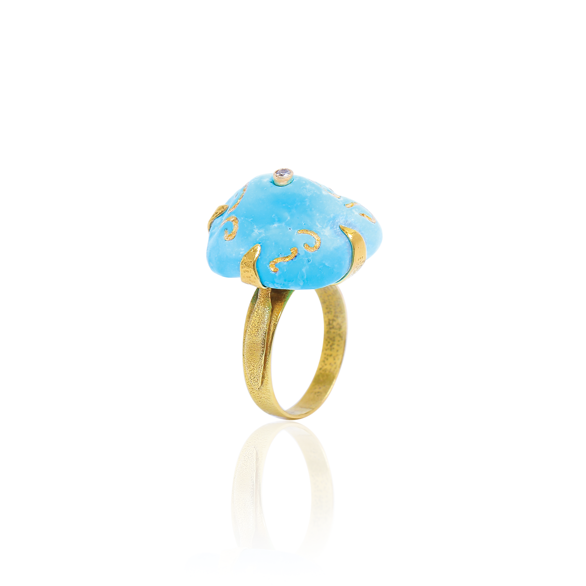 Ring with blue stone and gold accents on a white background
