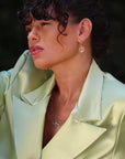 Beautiful Brunette Model wearing Marilisi Emerald Earrings Asymmetry full shot