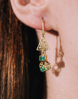 Model wearing gold and emerald unique designer jewelry earrings by marilisi