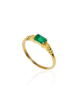 Gold ring with a green gemstone on a white background
