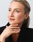 Woman wearing a black blazer with a neutral background