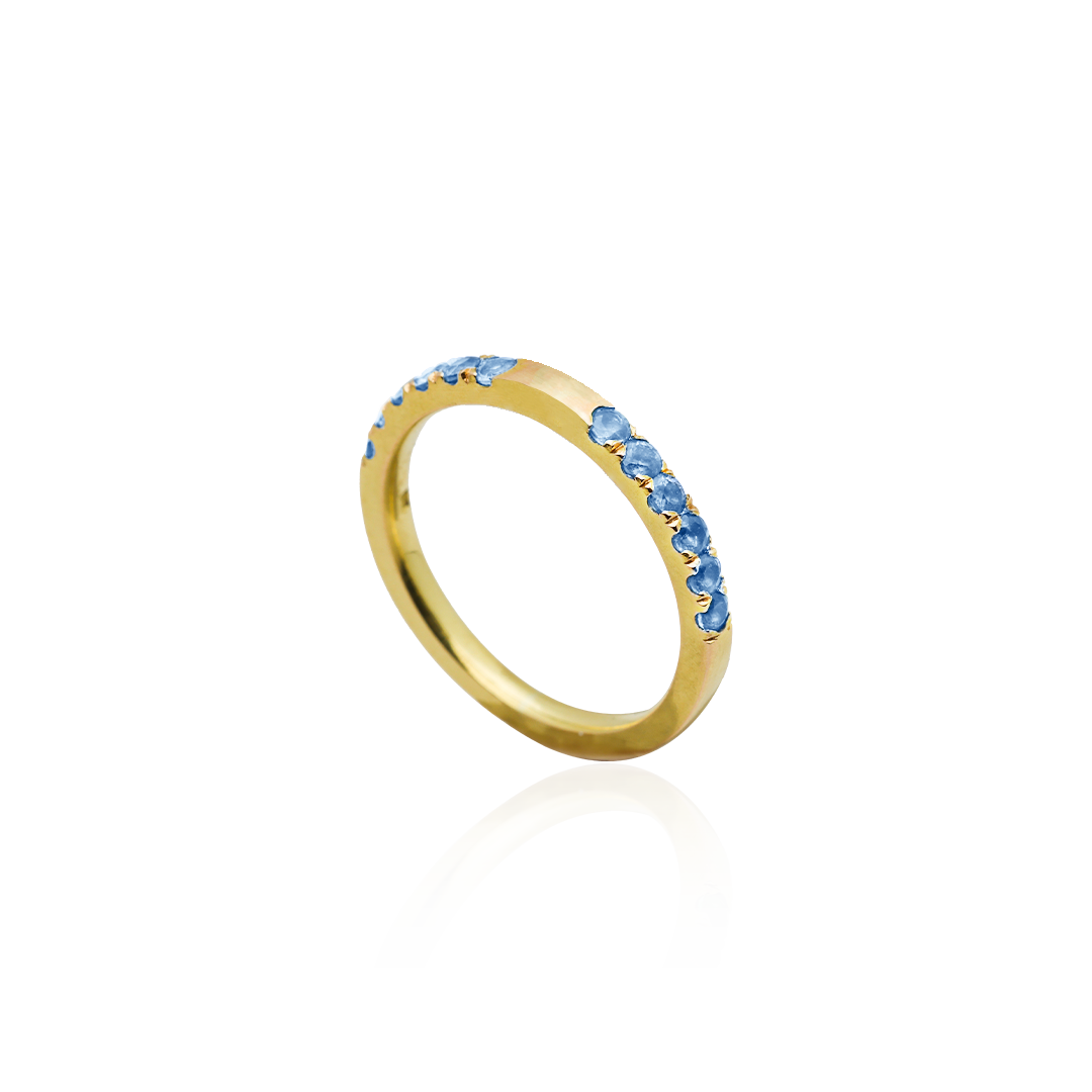 Gold ring with blue gemstones on a white background