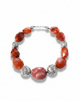 Necklace with red and silver beads on a white background