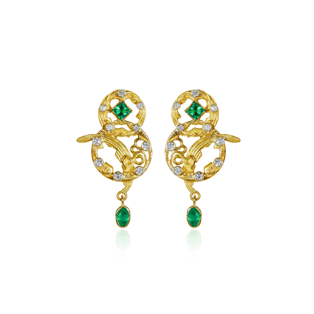 Gold earrings with green gemstones on a white background