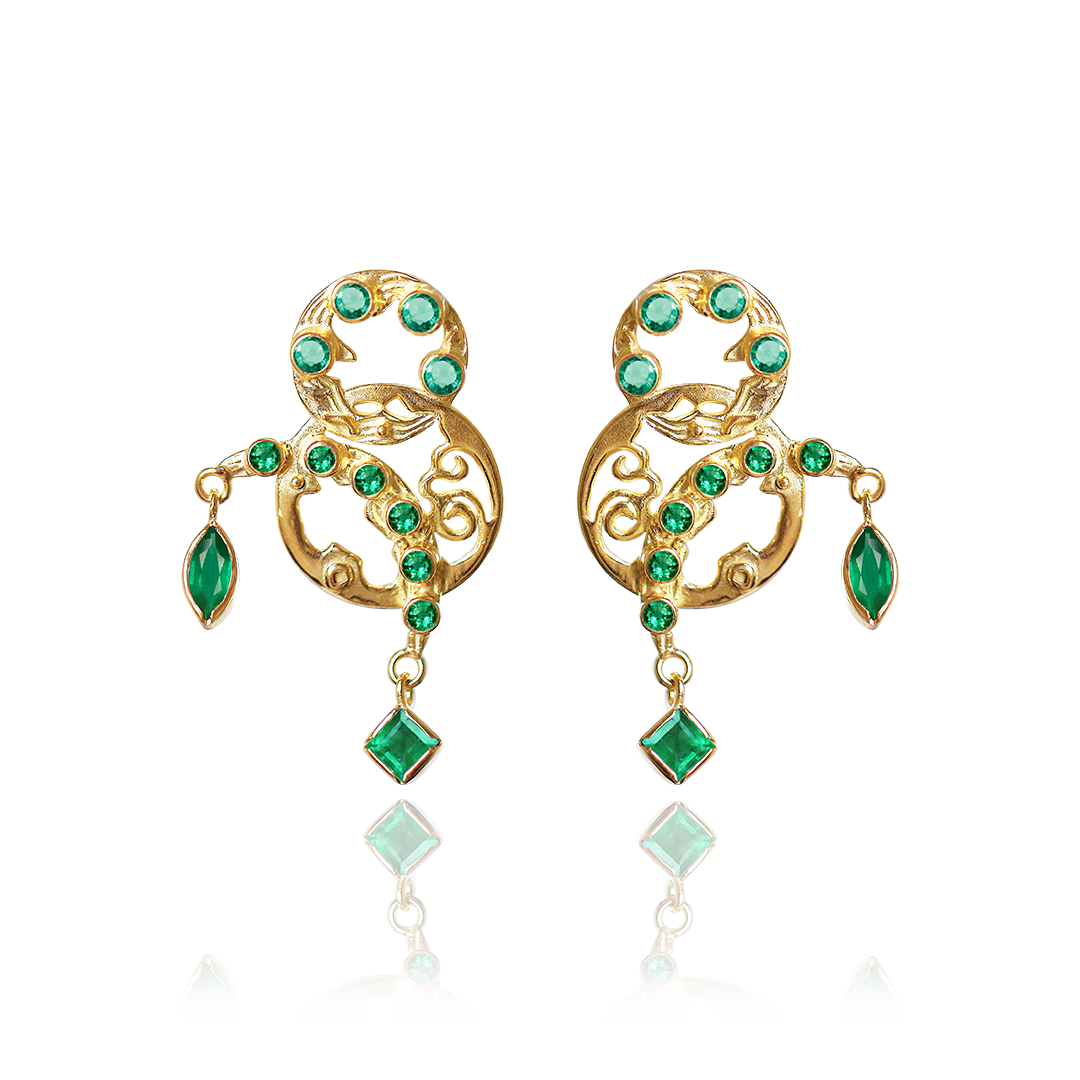 Gold earrings with green gemstones on a white background