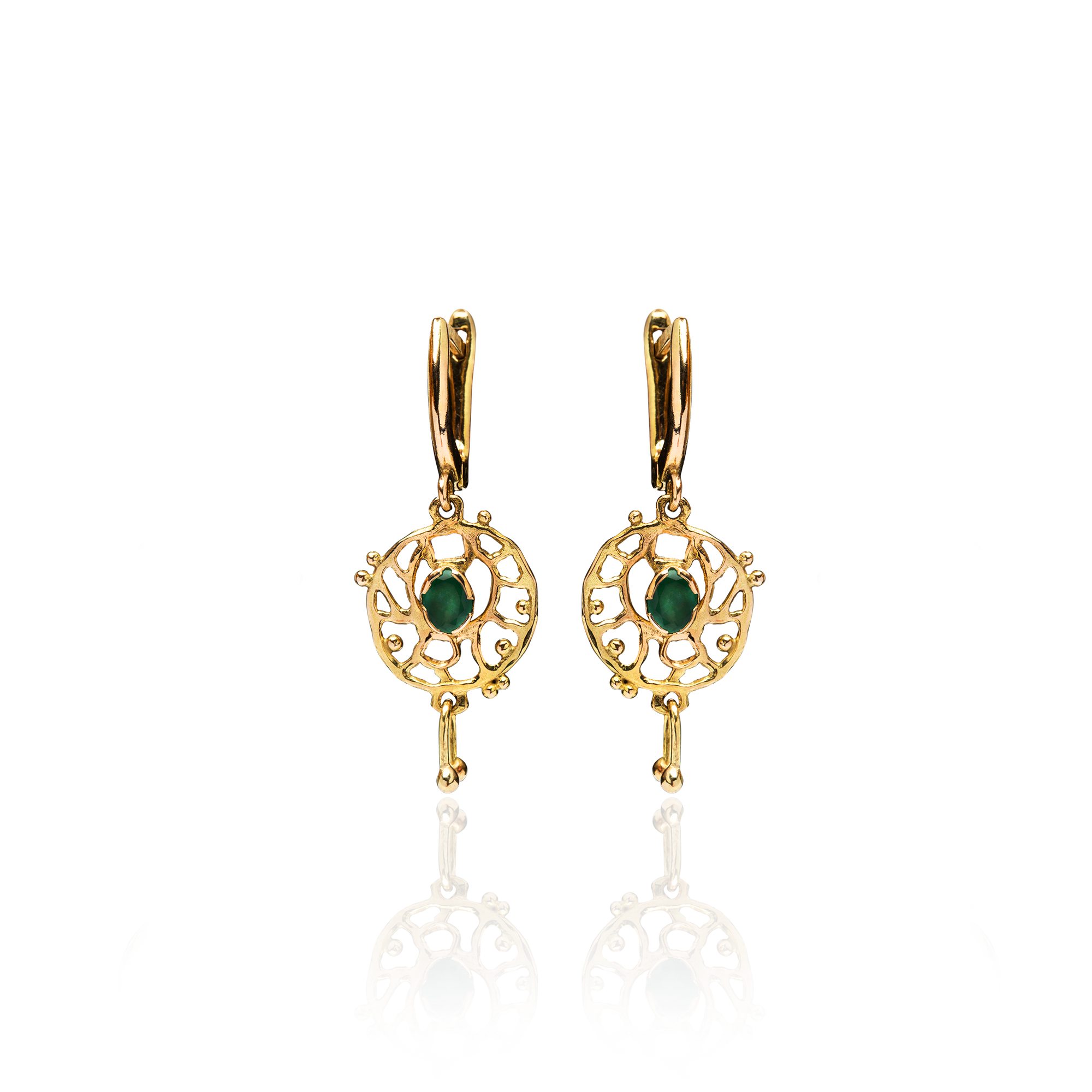 Gold earrings with green gemstones on a white background