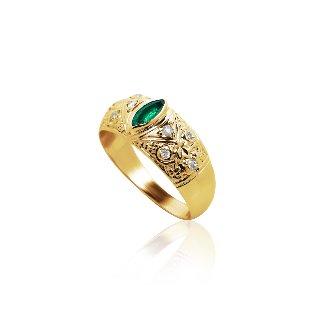 Gold ring with emerald and diamonds on a white background