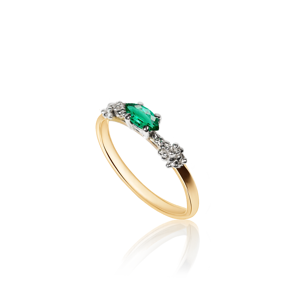 Gold ring with a green gemstone on a white background