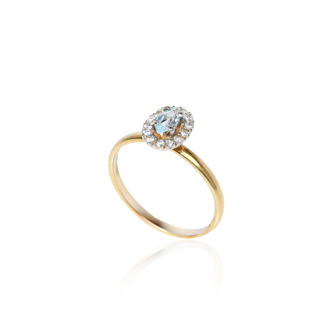Gold ring with a diamond on a white background