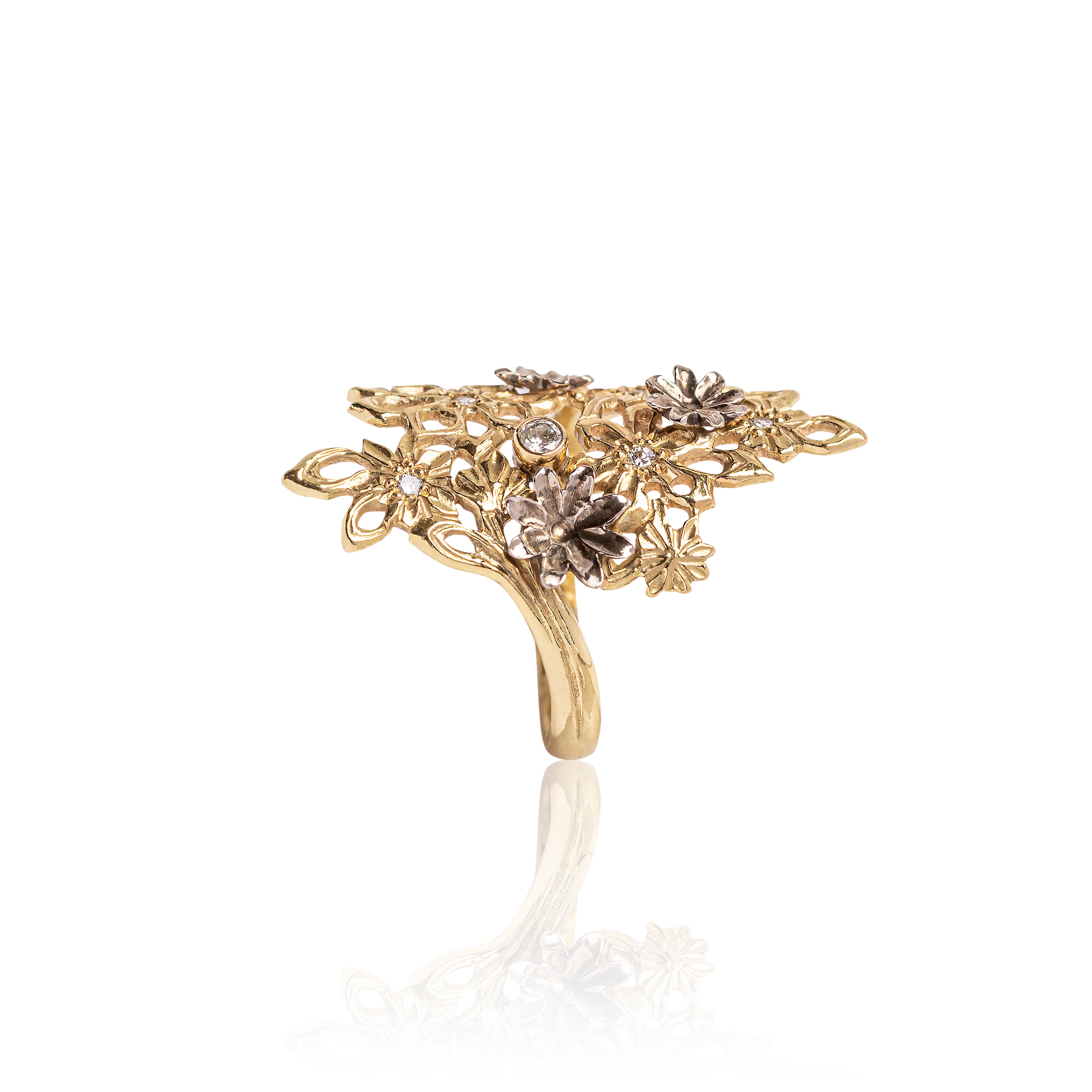 Gold ring with floral design and embedded stones on a white background