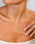 Gold necklace with on a person's neck