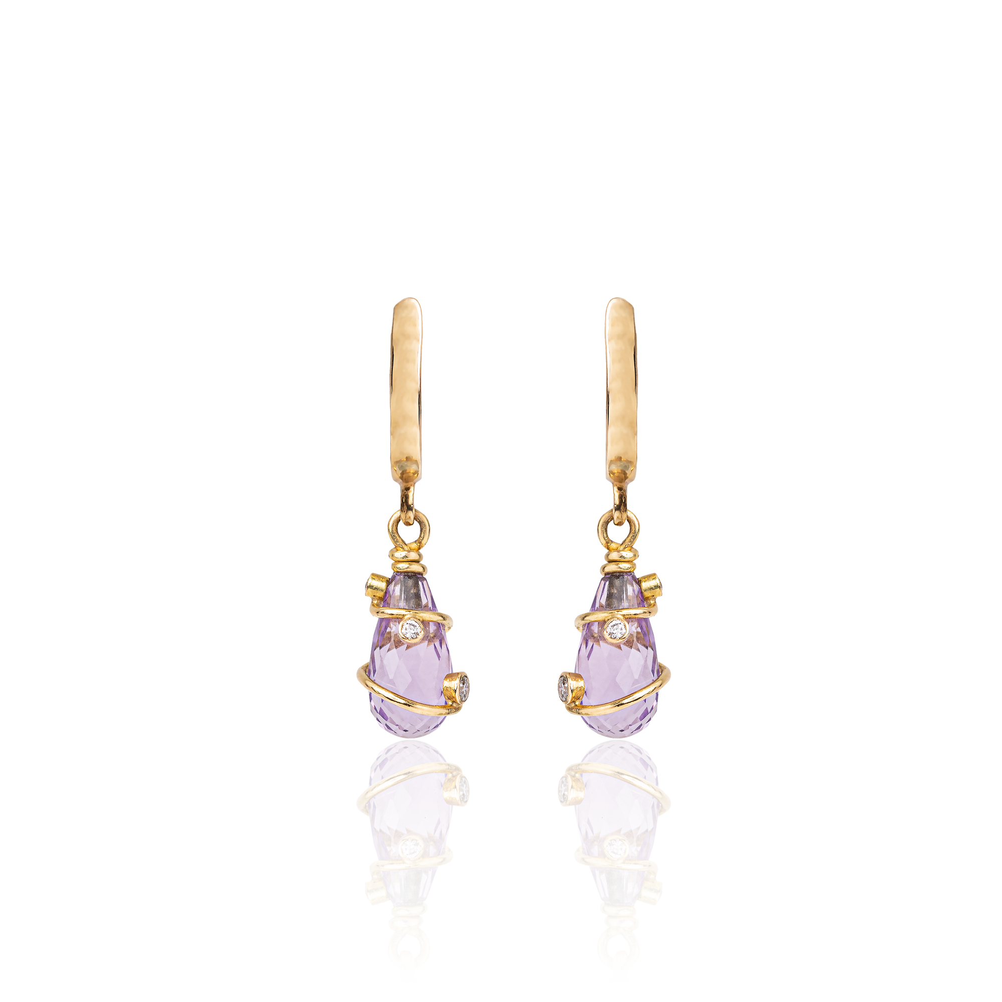 Gold earrings with purple teardrop-shaped gemstones on a white background