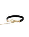 Black rubber bracelet with gold accents on a white background