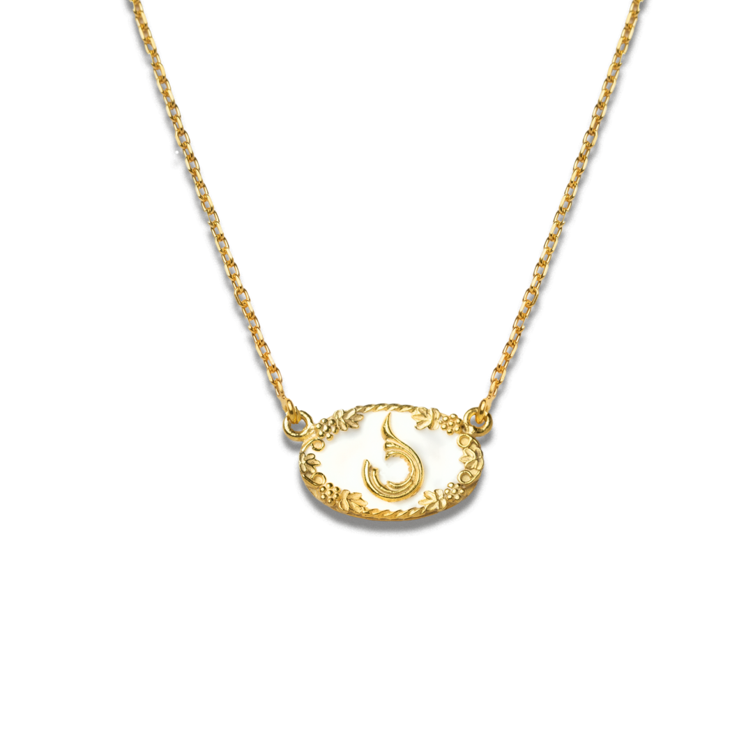 Gold necklace with a decorative pendant on a white background