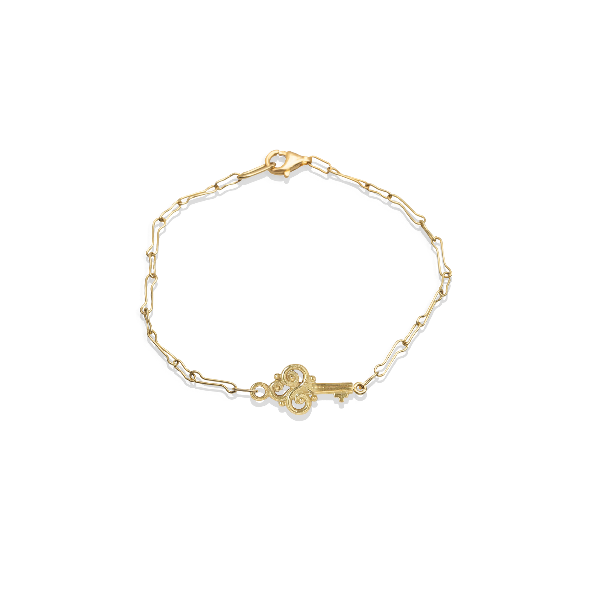 Gold bracelet with a key charm on a white background