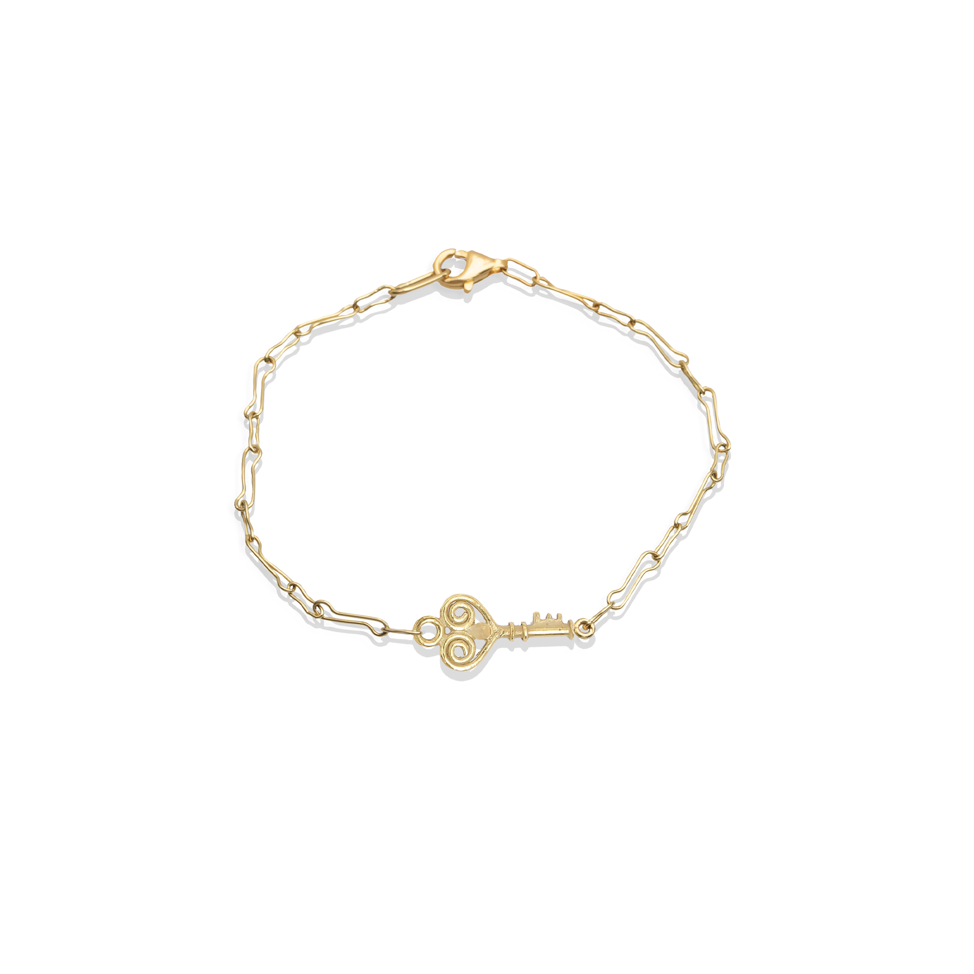 Gold bracelet with a key charm on a white background