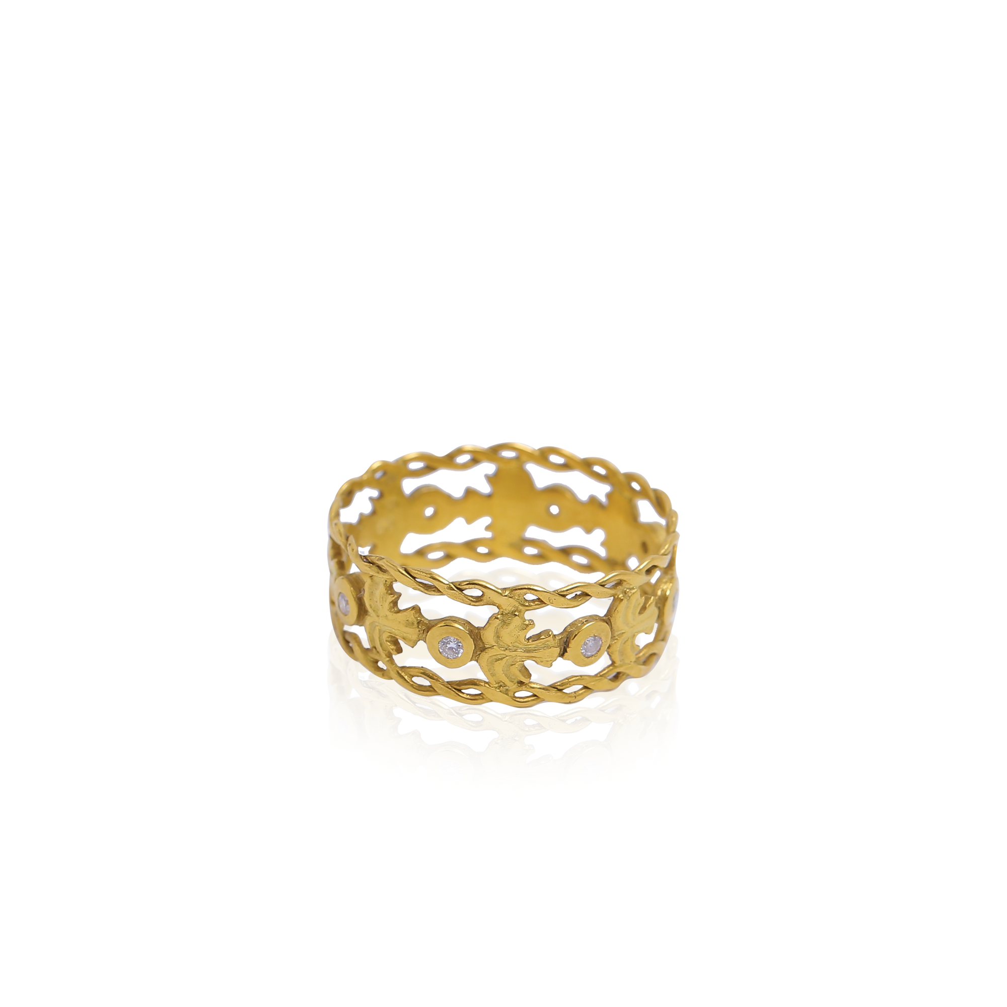 Gold ring with intricate design on a white background