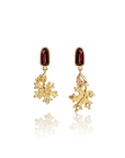 Gold leaf-shaped earrings with red gemstones on a white background