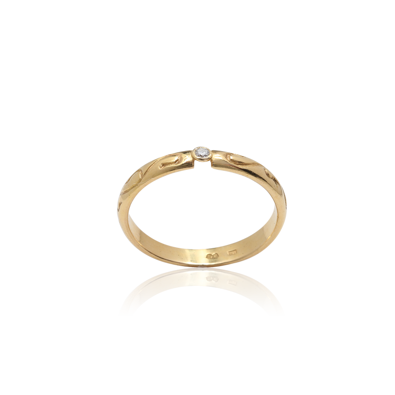 Gold ring with a diamond on a white background