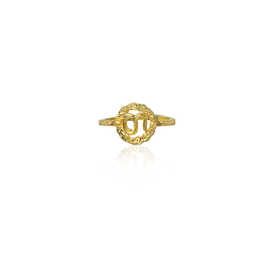 Gold ring with a decorative design on a white background