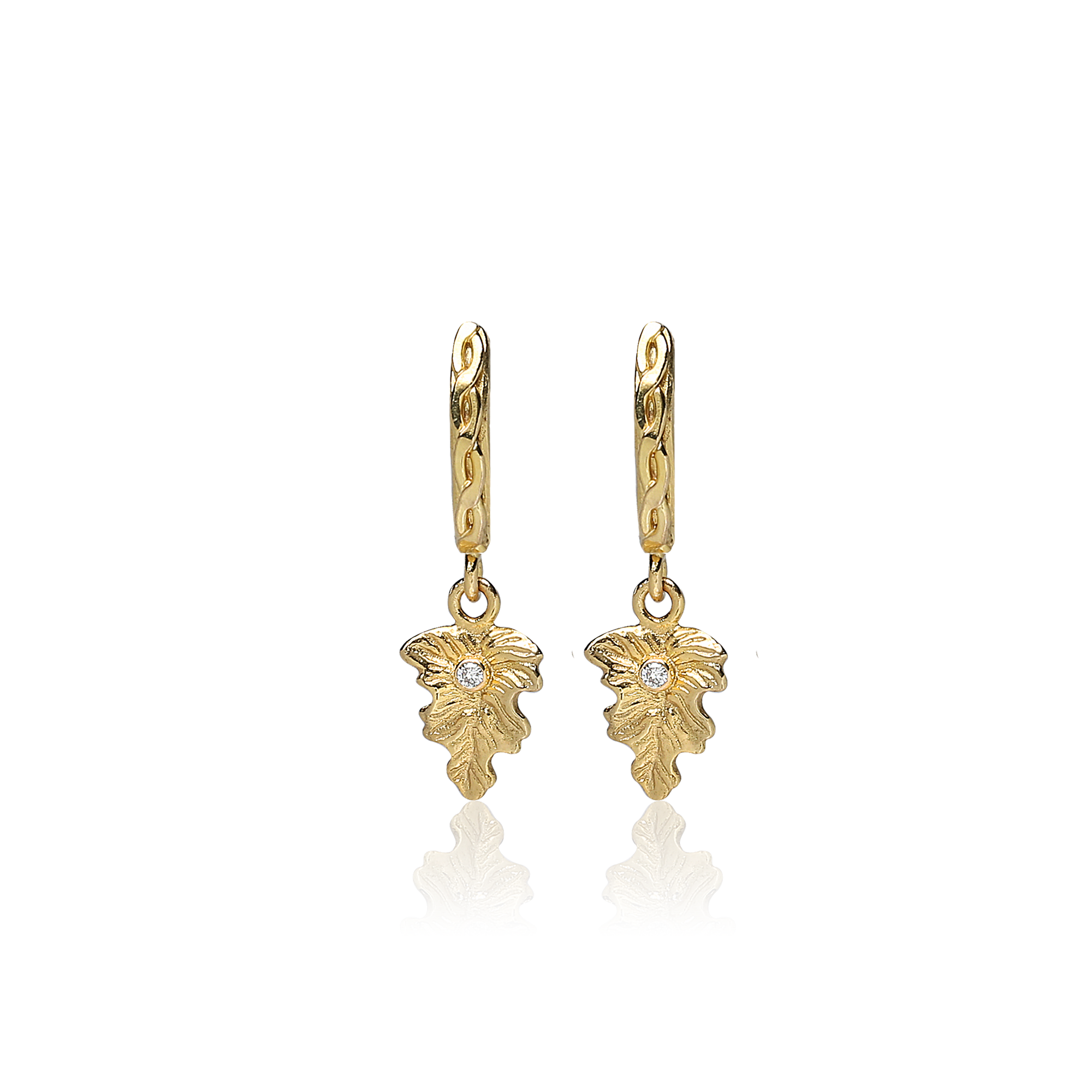 Gold leaf-shaped earrings on a white background