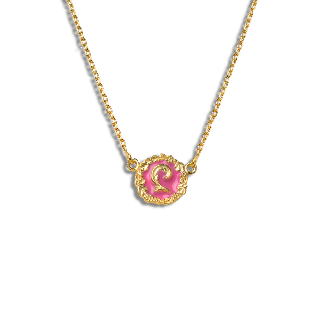 Gold necklace with a pink pendant on a white background