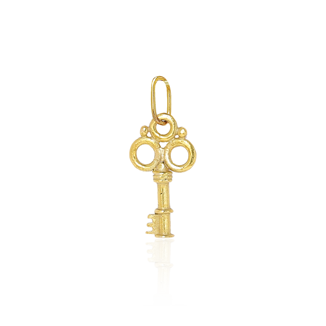 Gold key-shaped pendant on a white background