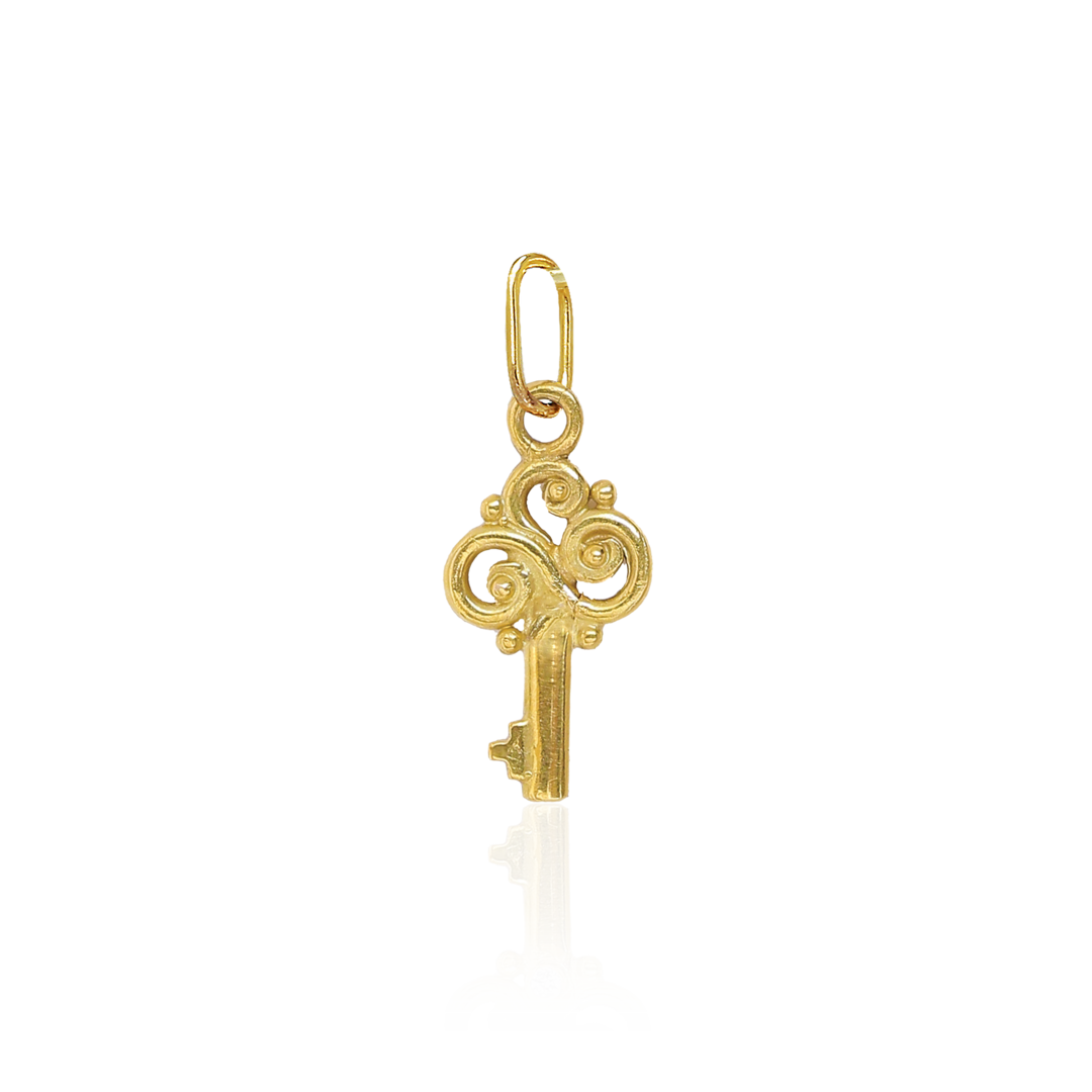 Gold key-shaped pendant on a white background