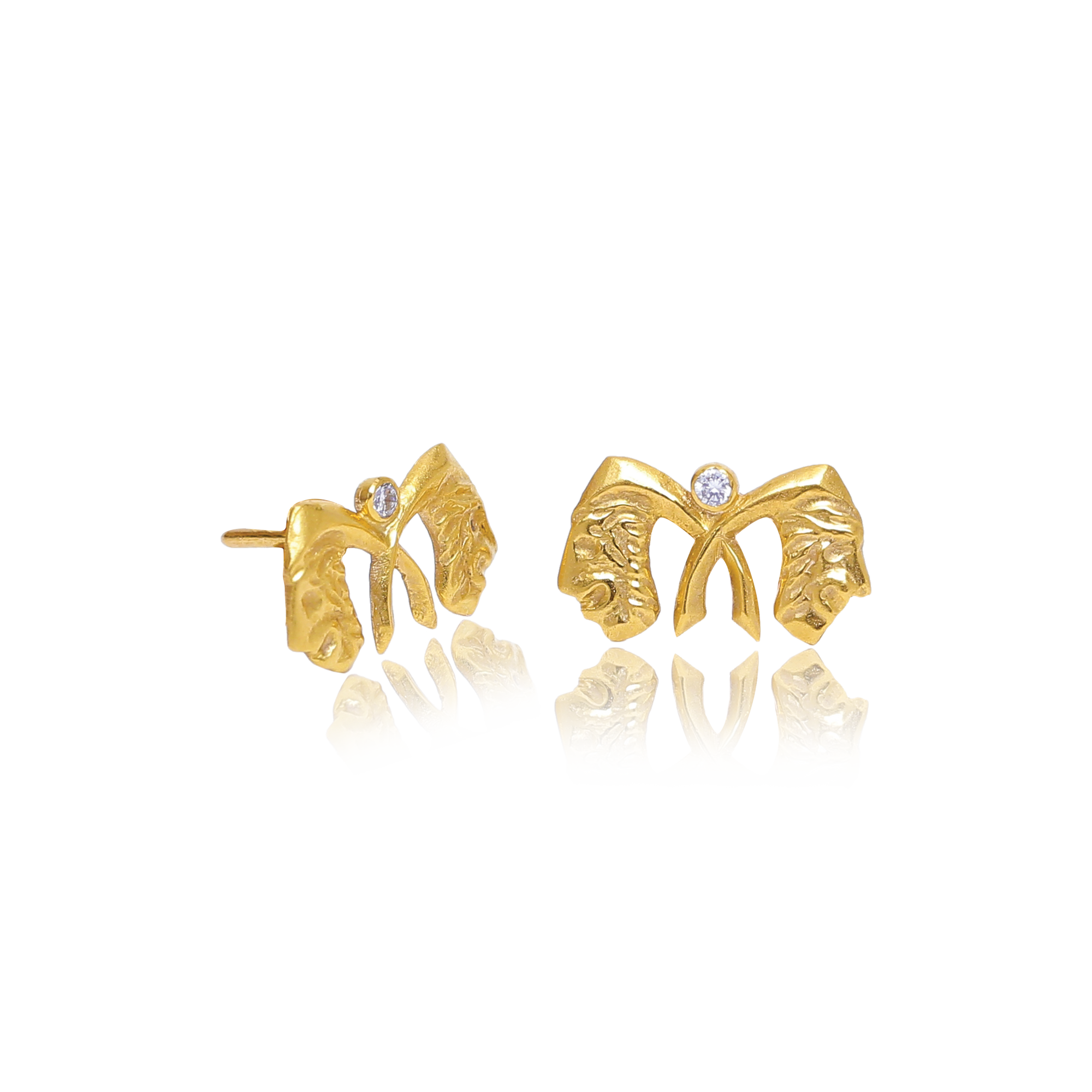 Gold butterfly-shaped earrings on a white background