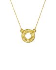 Gold necklace with a circular pendant on a white background