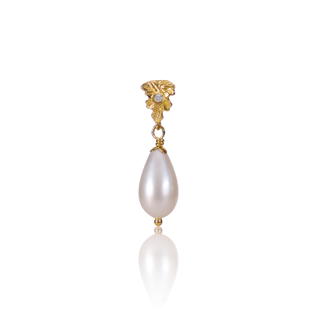 Gold earring with two pearl drops on a white background