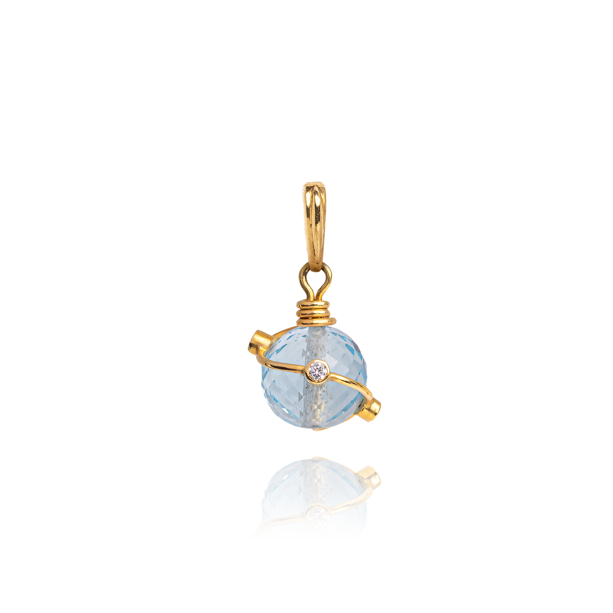 Gold pendant with a blue gemstone on a white background