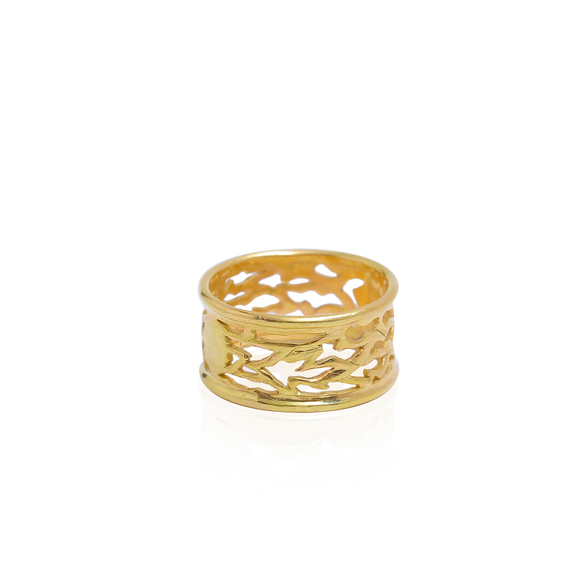 Gold ring with a leaf-like pattern on a white background