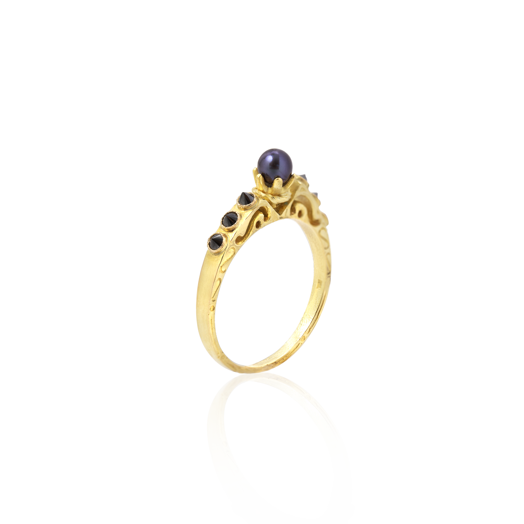 Gold ring with a purple gemstone on a white background