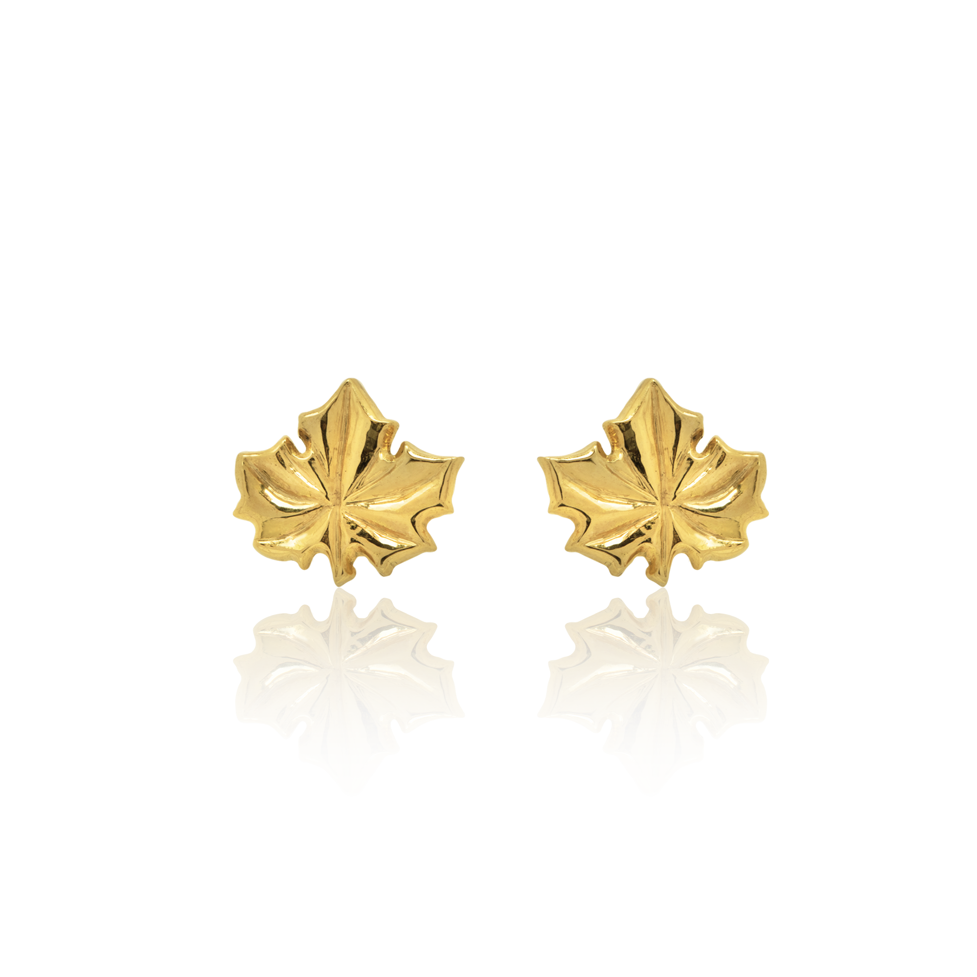 Gold maple leaf earrings on a white background