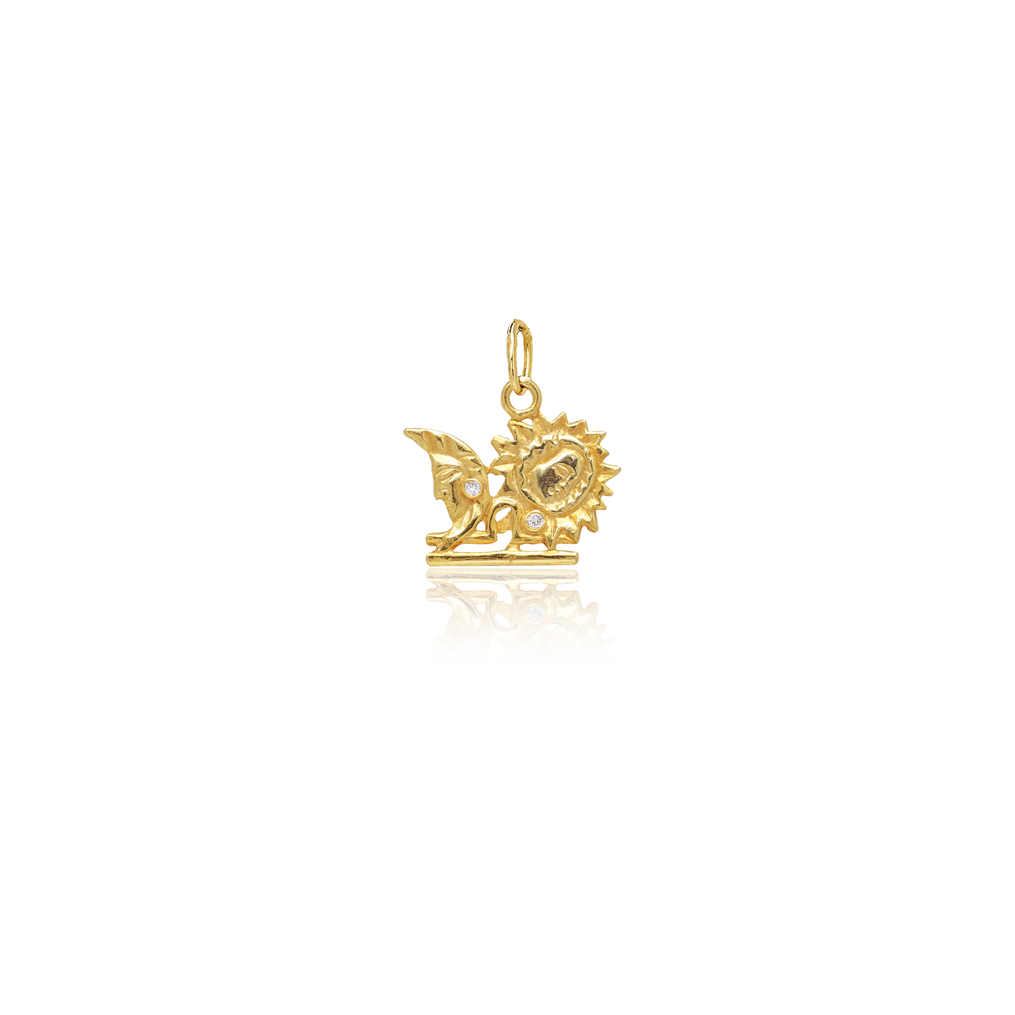 Gold pendant with a sun design on a white background